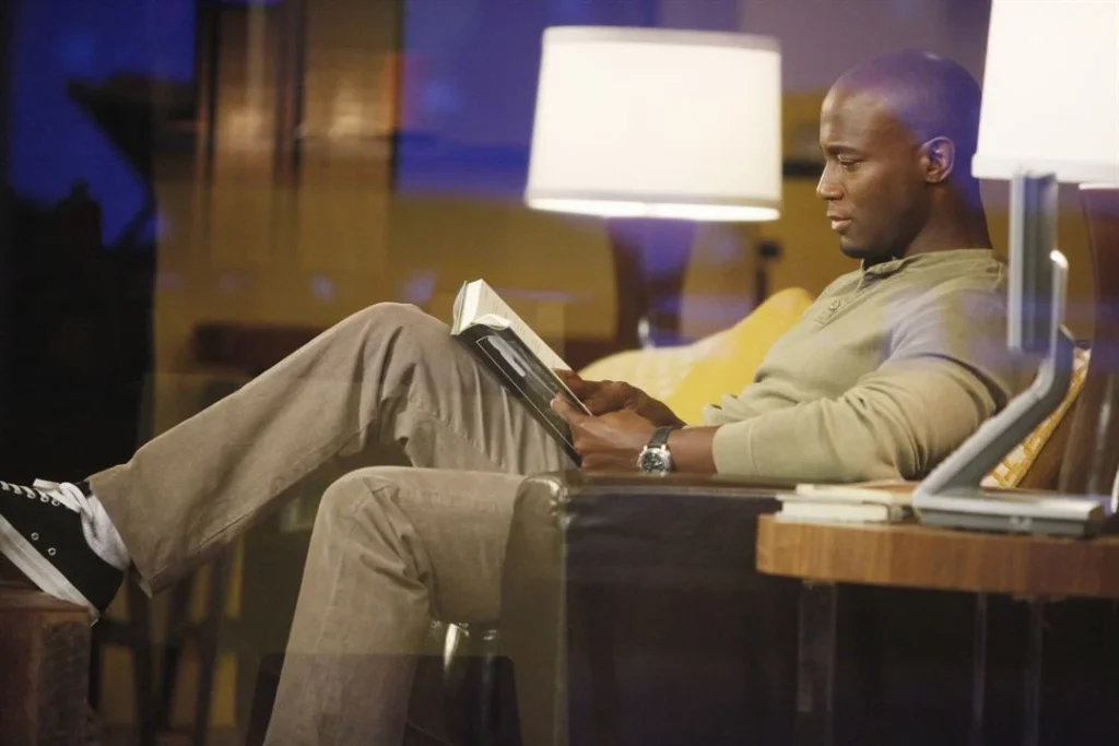Taye Diggs reads a book in an episode of private practice.