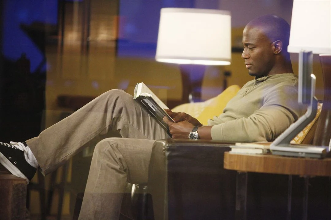 Taye Diggs reads a book in an episode of private practice.